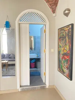 a hallway with an open door to a living room at HF - residency in Luxor