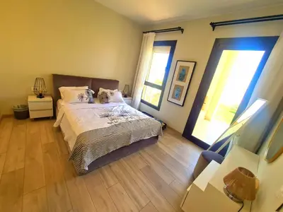 a bedroom with a bed and two windows at شيدوان الجونة in El Gouna