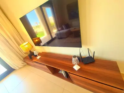 a wooden bench in a living room with a mirror at شيدوان الجونة in El Gouna