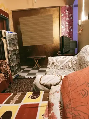 a living room with a couch and a table at الشواربي السياحي سوق الحارث in Aswan