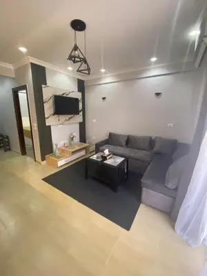a living room with a couch and a table at Hurghada Jungle Clube House Compound 1 bedroom Хургада компаунд студия в Джангл с 1 спальней in Hurghada