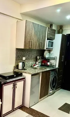 a kitchen with a sink and a dishwasher at Cecilia resort hurghadaمنتجع سيسيليا in Hurghada
