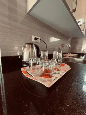 a group of glasses on a counter in a kitchen at Rooftop in Hurghada with seaview and private terrace in Hurghada