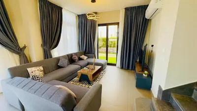 a living room with a couch and a table at Ollystays 4BR Villa Heated Pool El Gouna in Hurghada