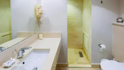 a white bathroom with a sink and a toilet at Ollystays Mangroovy 3BR Beach and Pool Free access in Hurghada