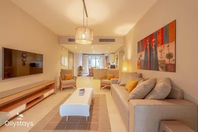 a living room with a couch and a table at Ollystays Mangroovy Seaview 2BR Beach and Pool Free access in Hurghada