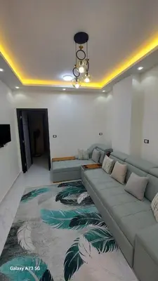 a living room with a couch and a large rug at الغردقه in Hurghada