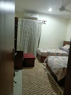 a hotel room with two beds and a window at Appartment in Hurghada in Hurghada