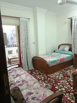 a bedroom with a bed and a window and a bed sidx sidx sidx at Appartment in Hurghada in Hurghada