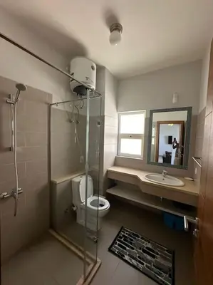 a bathroom with a shower and a toilet and a sink at waterside apartments in Hurghada