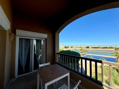 a balcony with a table and a view of a river at waterside apartments in Hurghada