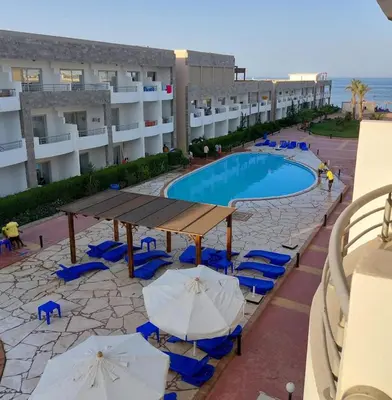 a view of a swimming pool with chairs and umbrellas at Cecilia resort منتجع سيسيليا in Hurghada