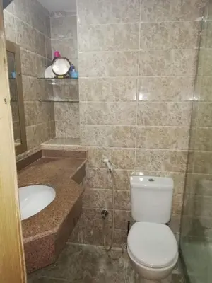 a bathroom with a toilet and a sink at Cecilia resort منتجع سيسيليا in Hurghada