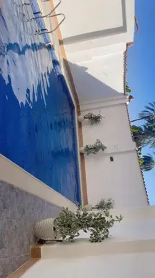 a painting on the side of a building with plants at Mado luxury villa with private pool in Luxor