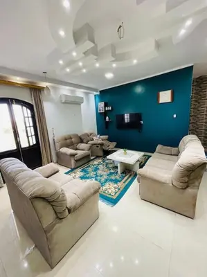 a living room with couches and a blue wall at Mado luxury villa with private pool in Luxor