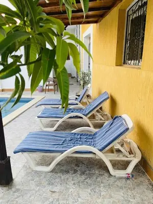three blue and white lounge chairs on a patio at Mado luxury villa with private pool in Luxor