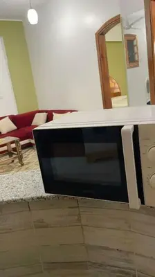 a living room with a tv sitting on the floor at El Hady villa with swimming pool in Luxor
