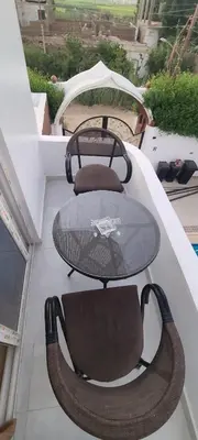 a glass table and chairs on a balcony at Luxor Sapphire in Luxor