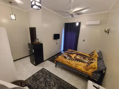 a bedroom with a bed and a television in it at Luxor Sapphire in Luxor