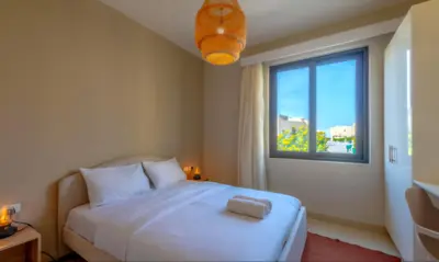 a bedroom with a white bed and a window at Luxury Villas in Tawila El Gouna in Hurghada