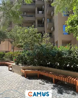 a park with benches in front of a building at CAMUS 110 A, Princess Resort in Hurghada