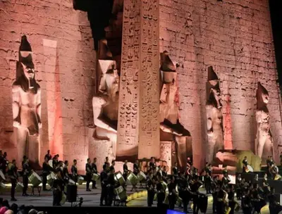 a group of people standing in front of a stone wall at Nile Cruise FB 3 Nights Aswan Luxor in Aswan