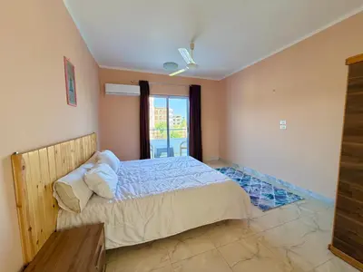 a bedroom with a large bed and a window at Sylvie guest house I in Luxor