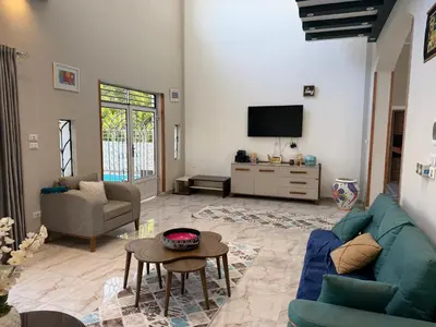 a living room with a blue couch and a tv at Sylvie guest house I in Luxor
