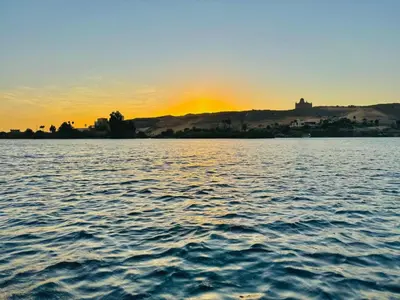 a sunset over a large body of water at Nile Bride in Aswan