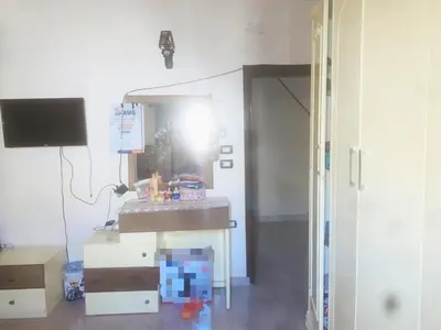 a room with a desk and a tv and a room with a table at Nubian rise in Aswan