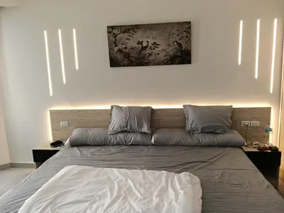 a bed in a bedroom with a painting on the wall at scandic resort sea view in Hurghada