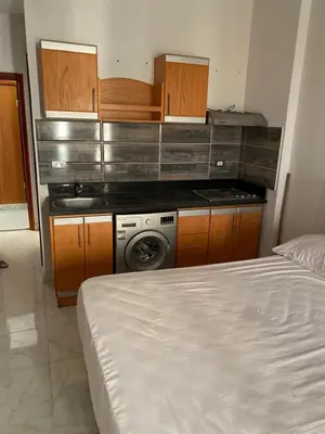 a kitchen with a stove and a washing machine at Tiba A F B View in Hurghada