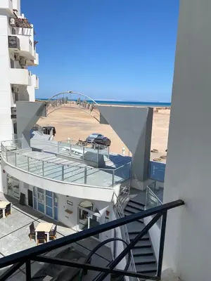 a balcony of a building with a view of a beach at Tiba A F B View in Hurghada