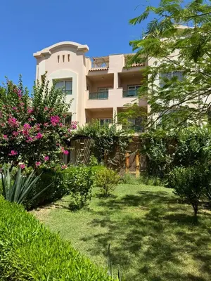 a building with a garden in front of it at Cozy Sunny Studio with Pool View - Sahl Hasheesh in Hurghada