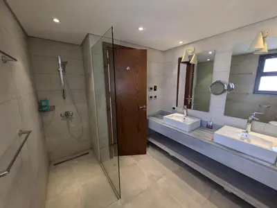 a bathroom with two sinks and a shower at Supreme Beachfront 3BR Villa Soma bay with Garden in Hurghada