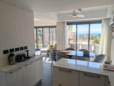 a kitchen and dining room with a view of the ocean at Supreme Beachfront 3BR Villa Soma bay with Garden in Hurghada