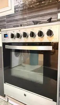 a stove with four pots on top of it at Spacious 3BR Apartment - Al Dora Resort, Hurghada in Hurghada