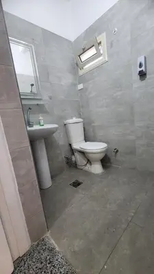 a bathroom with a toilet and a sink at White Roof - Hurghada in Hurghada