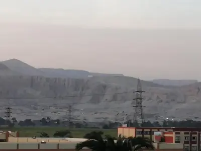 a view of a city with mountains in the background at Lutos Flower Apartment in Luxor