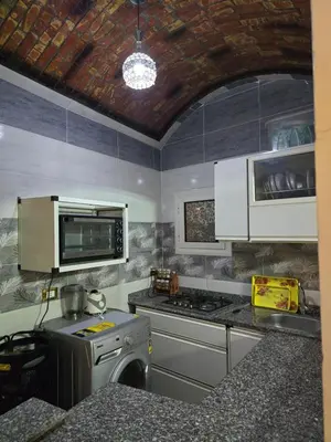 a kitchen with a stove and a stove top oven at Rammy Guest House in Aswan