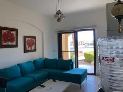 a living room with a blue couch and a table at one bedroom ground floor sabina elgouna in Hurghada