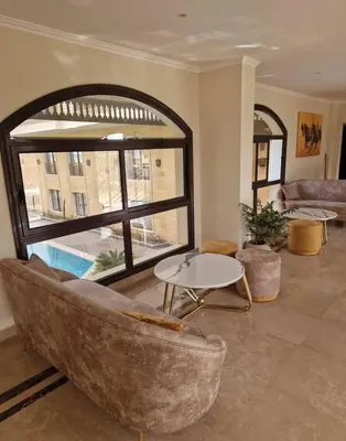 a living room with a couch and a large window at Aqua blue bay in Hurghada