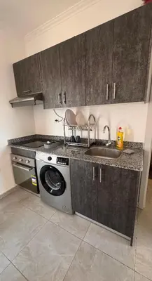 a kitchen with a washing machine and a sink at Aqua blue bay in Hurghada