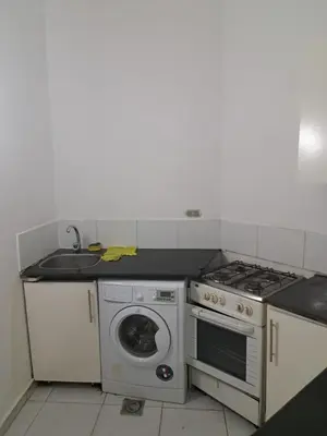 a kitchen with a stove and a washing machine at Desert Bearl compound in Hurghada