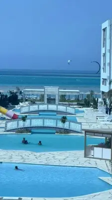 a large swimming pool with the ocean in the background at Fanadir bay compound in Hurghada
