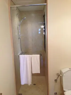 a bathroom with a shower with white towels at Cozy studio with a view in port ghalib in Marsa Alam