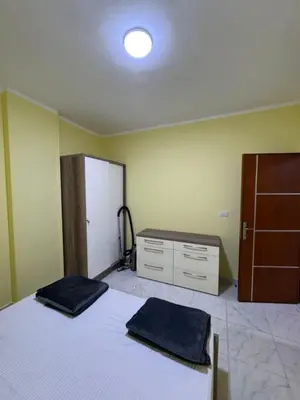 a bedroom with a bed and a dresser and a closet at Tiba View in Hurghada