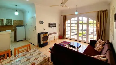 a living room with a couch and a kitchen at Blue Lotus House in Luxor