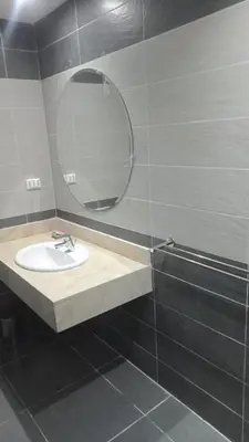 a bathroom with a sink and a mirror at Fanadir Bay Compound in Hurghada