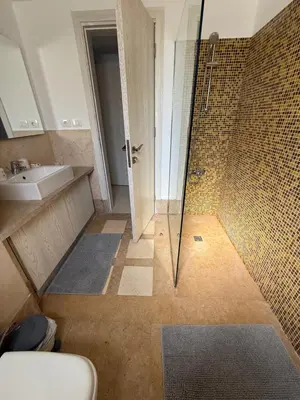 a bathroom with a shower and a sink at Elite 3bdr apartment with garden beside corral reef in Hurghada